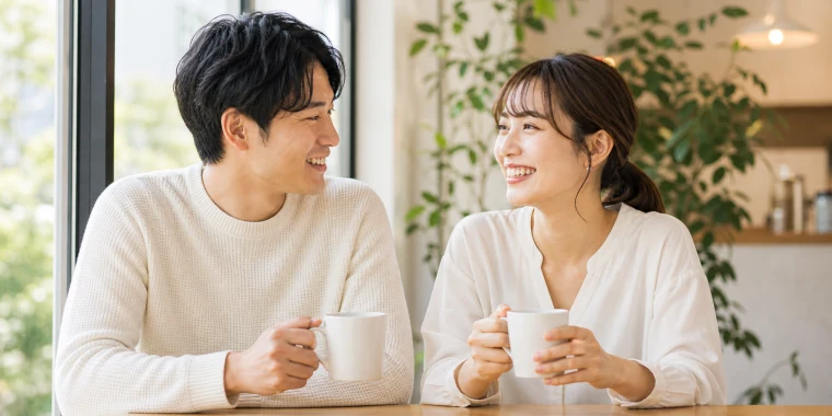 明るいカフェで自然に会話する20代後半の男性と30代前半の女性